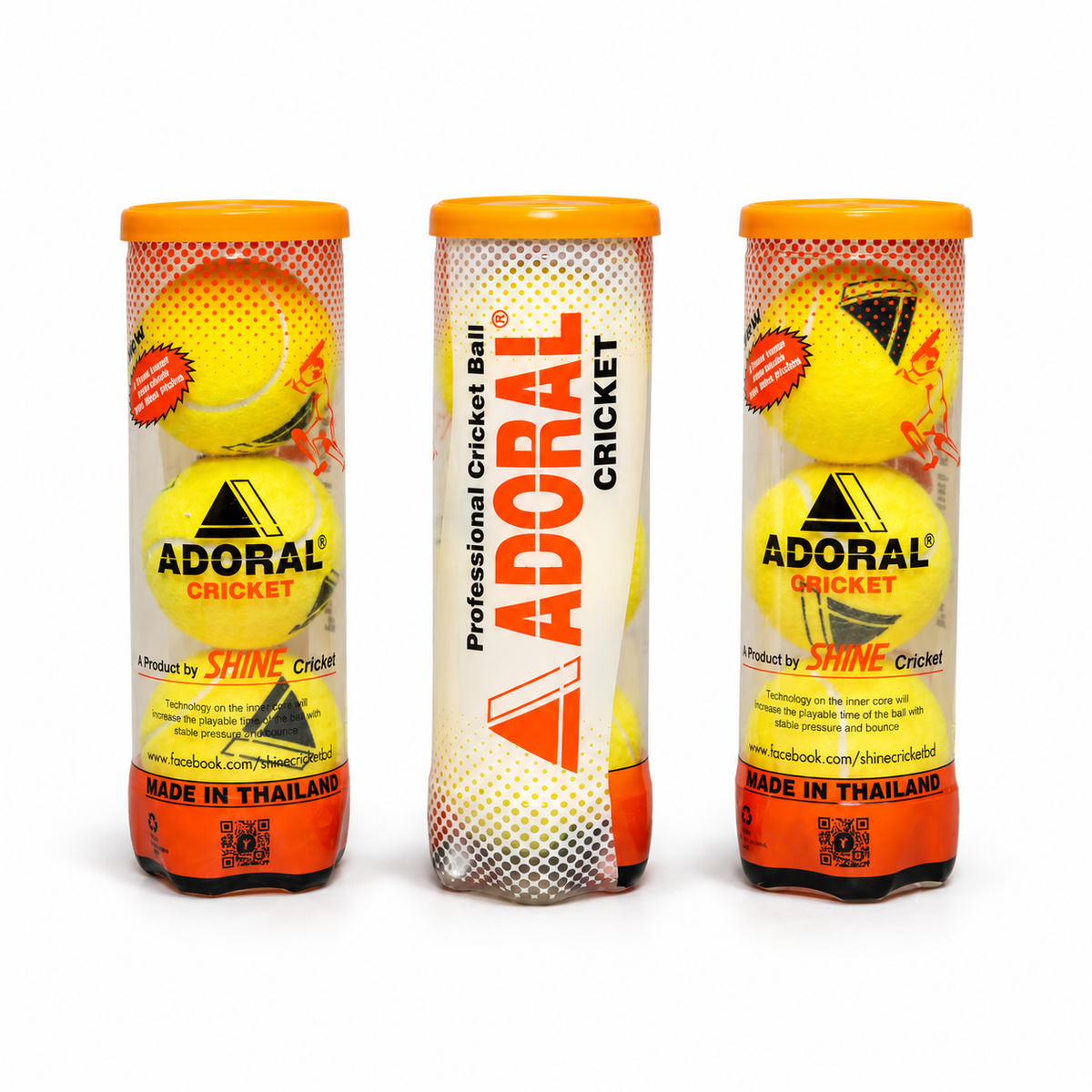 Three Adoral cricket ball tubes with yellow balls, orange lids and Shine Cricket packaging